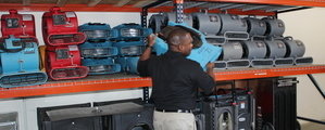 Technician Prepping Air Movers For Water Damage Job